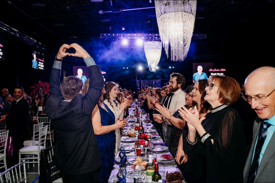 During the Bonnyville Health Foundation 25th silver anniversary gala, Dr. Leonard De Freitas held his hands in a heart while the crowd gave a standing ovation in honour of the physicians who received awards for their 25+ years of service at the Bonnyville Health Centre