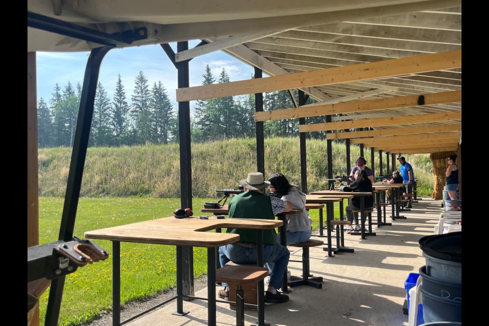 Volunteer Bruce Brine teaching a shooter how to use a scope for aiming, during the the Ladies Shoot hosted by the Bonnyville Shooting Sports Association.