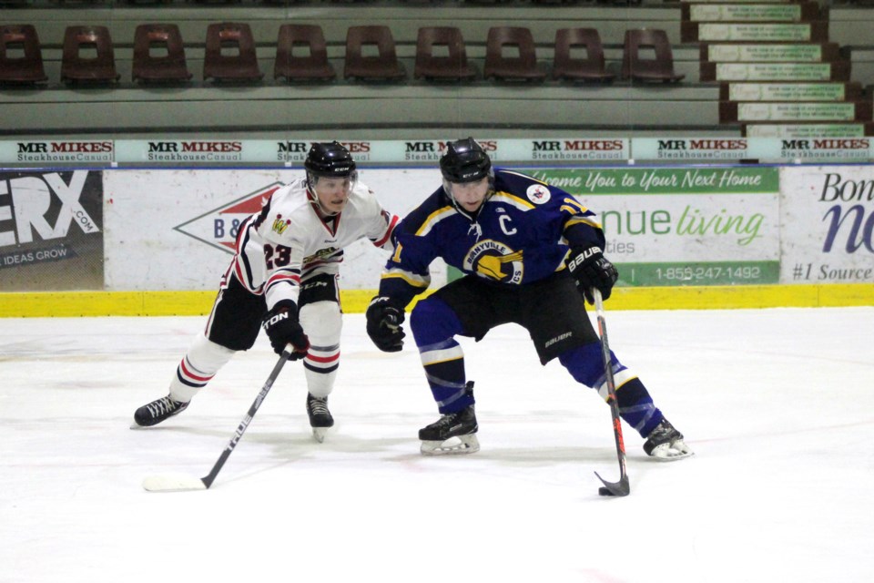 During the Bonnyville Sr. AA Pontiacs game against the Westlock Warriors on Sunday, Jan. 5, Lucas Isley fights for control of the puck. Photo by Robynne Henry. 