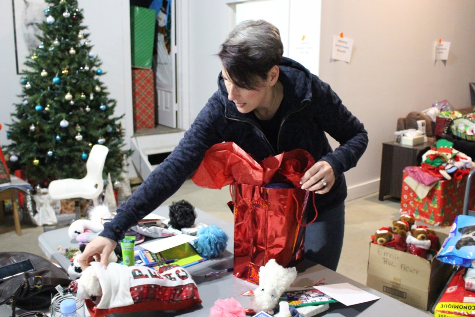 Sandra Evans finished up the last couple of gifts for Stockings 4 Seniors in the Bonnyville and Cold Lake area at their headquarters on Saturday, Dec. 21. Photo by Robynne Henry