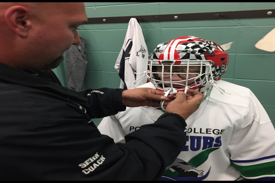 Local minor hockey officials have been taking player registrations and lining up coaching staff for the upcoming season — preparing to go ahead once protocols are in place.  File Photo: Peewee coach Boyd Sehn checks the equipment of the teams goalie before a practice on the Bold Center ice.