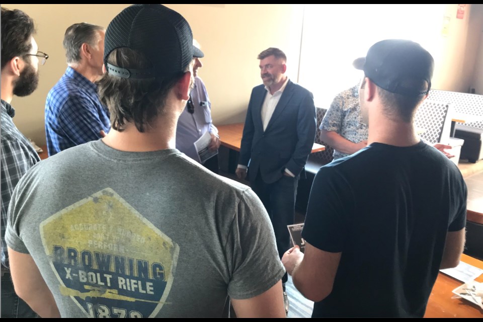 Alberta Energy Minister Brian Jean speaks with Lac La Biche County resident Peter Kirylchuk and other residents during his recent provincial election campaign.