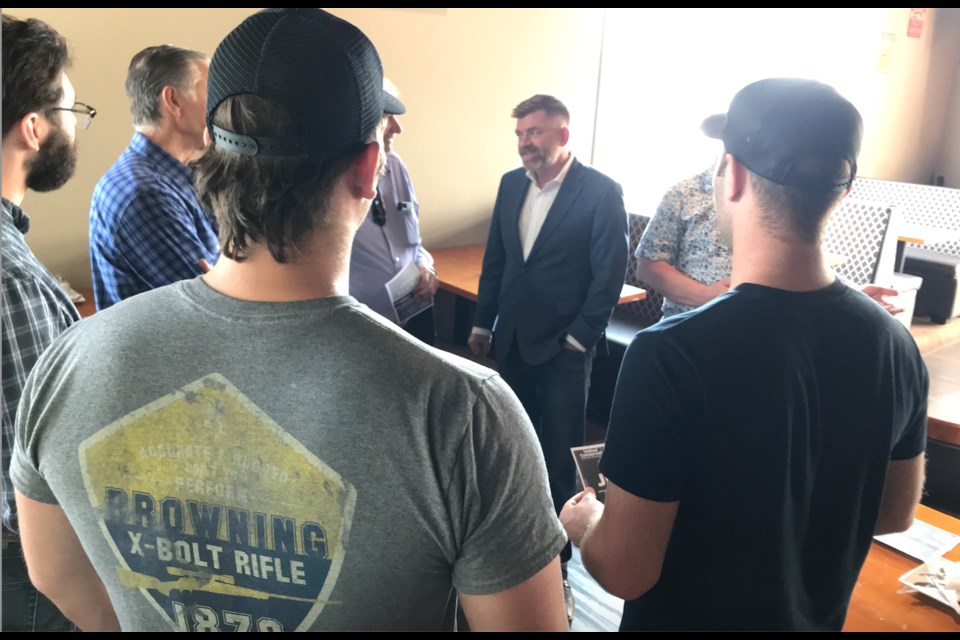 Fort McMurray-Lac La Biche UCP candidate Brian Jean speaks with Lac La Biche County resident Peter Kirylchuk and other residents during a lunch-time 'eat-and-greet at the Fat Unicorn restaurant in Lac La Biche onf Friday.