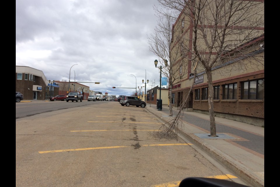 The snapped branch one one of the downtown decorative trees was left for days in front of the now-abandoned La Biche Inn. Derelict and unkempt properties can promote higher rates of crime, say a local committee.
