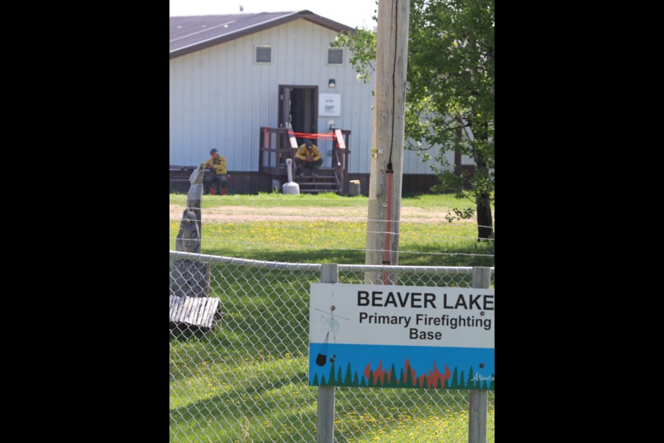 A few wildland firefighters spend some downtime at the Beaver Lake firefighting base camp. A fire inside one of the bunkhouse trailers brought Lac La Biche County fire crews on Wednesday afternoon