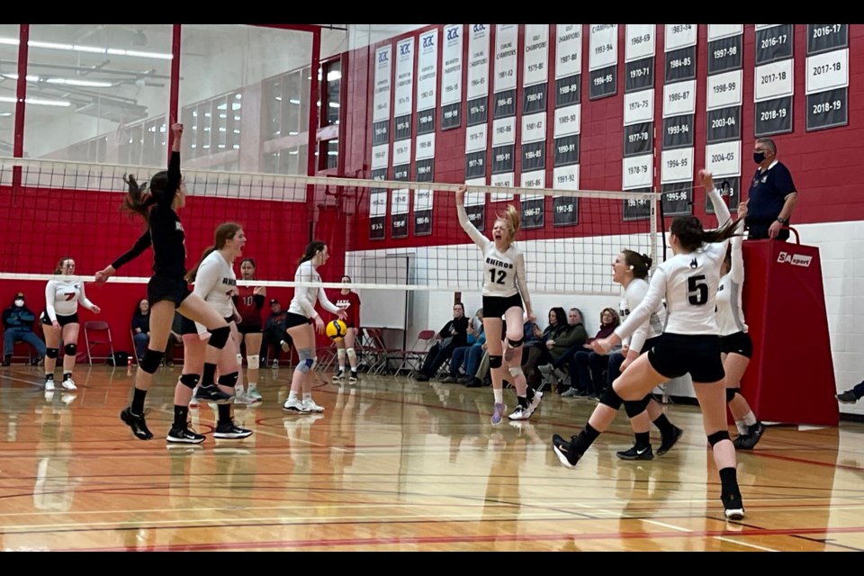 The 18U White Rhinos celebrate achieving an Ace point off their serve. 