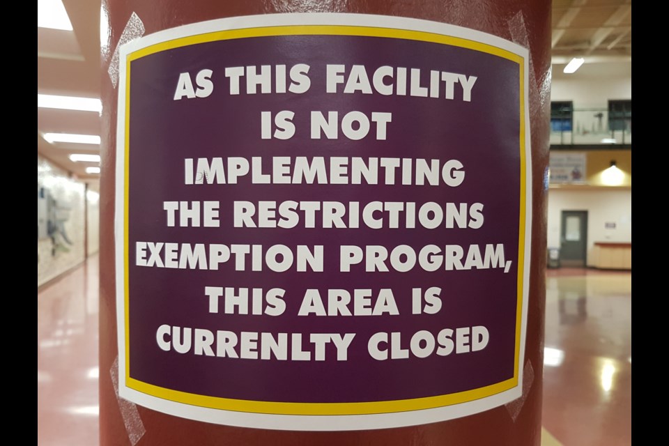 Larger and bolder signs appear at the C2 informing patrons that the facility is not participating in the province's Restriction Exemption Program.