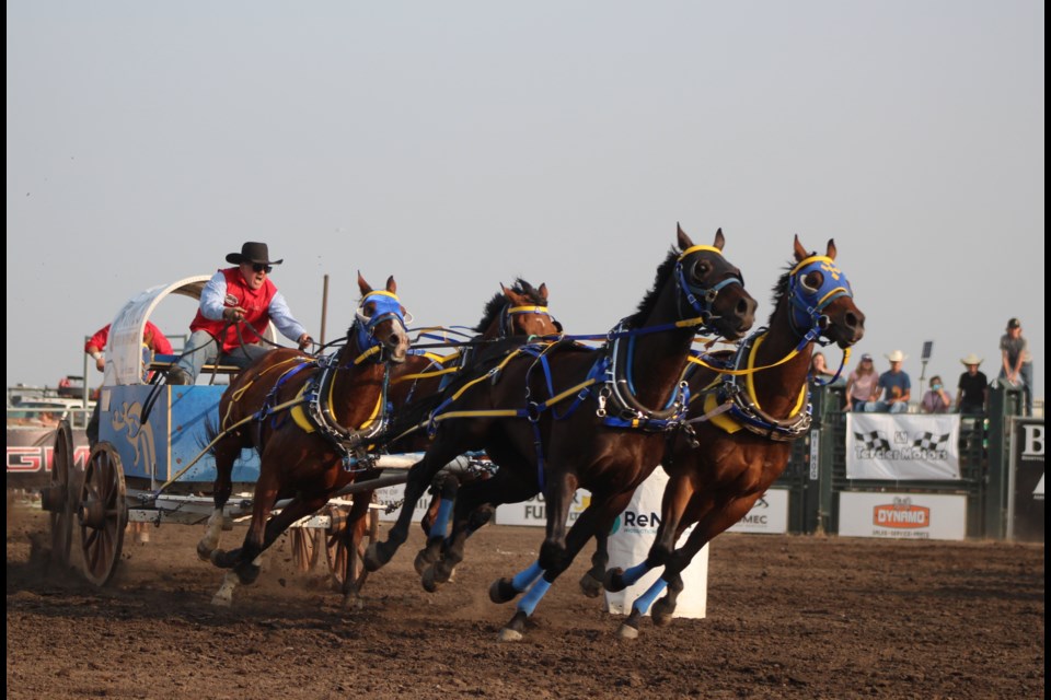 Driving under the Tomco group tarp is Codey McCurrach on June 10 at the Bonnyville chuckwagon races.