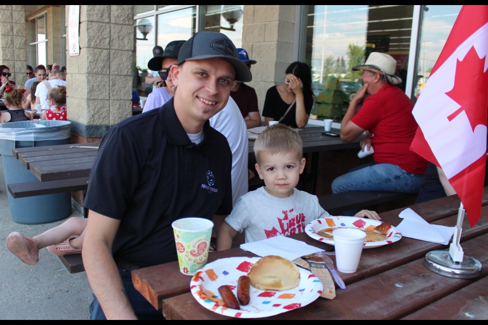 Large crowds stopped by the Sobey's parking lot on Saturday morning to grab a bite to eat at the Pancake Breakfast that supports the Bonnyville and District Historical Society. Pictured is Ryan (left) and Luca (right) Friend.