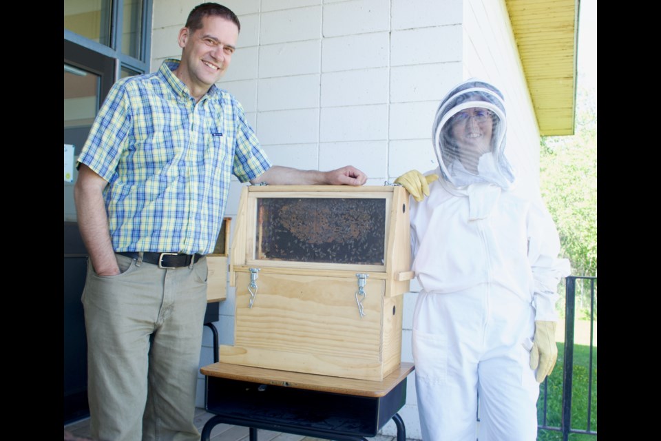 Rob and Joanne Wicker (right) presented a live bee colony to students at Vera M. Welsh School in Lac La Biche on June 21. The students’ got a first hand lesson on bee operations from the duo that operate Christ Creek Honey.