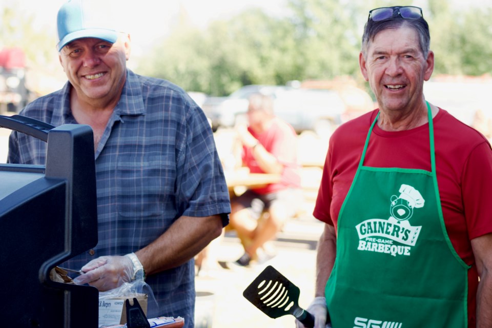 Sterling Johnson (left) and Les Irvine served up burgers and hot dogs during the Lac La Biche Co-op's 50-year anniversary on Aug. 26.