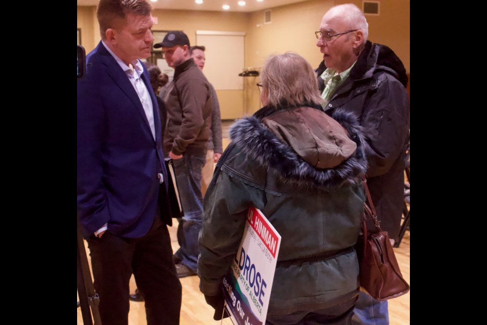UCP candidate Brian Jean speaks to a couple clearly showing signs of support for Wildrose Independence Party candidate Paul Hinman at a recent candidate debate in Lac La Biche.          Image: Rahma Dalmar
