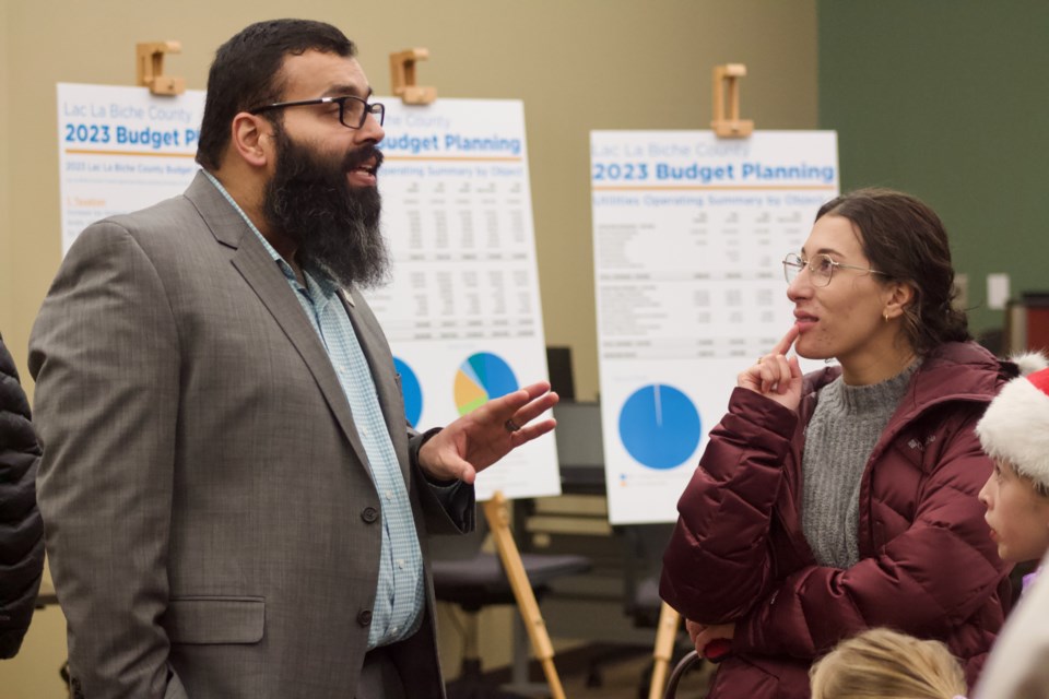 Zeeshan Hasan (left), Lac La Biche County's manager of finance, spoke with guests during a budget open house on Nov. 23.