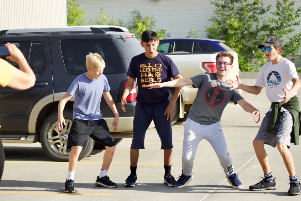 Over 20 youth in Lac La Biche made a trip down to Plamondon to join local teens on Thursday evening to participate in an Amazing Race style game hosted by Family and Community Support Services' (FCSS). The Black Team (Andrew Haxby, Emryk Lindskog, Layne Paul, Terrance Lindskog) recreated an earthquake scene challenge in public for three points.
