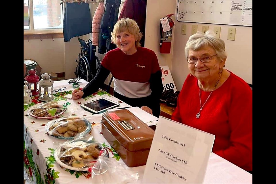 Rita Normand (left) Donna Warden (right) worked alongside a dozen United Church Women volunteers to bake, plate, wrap and sell 170 plates of holiday treats for St. John's United Church's annual Cookie Walk on Dec. 3.