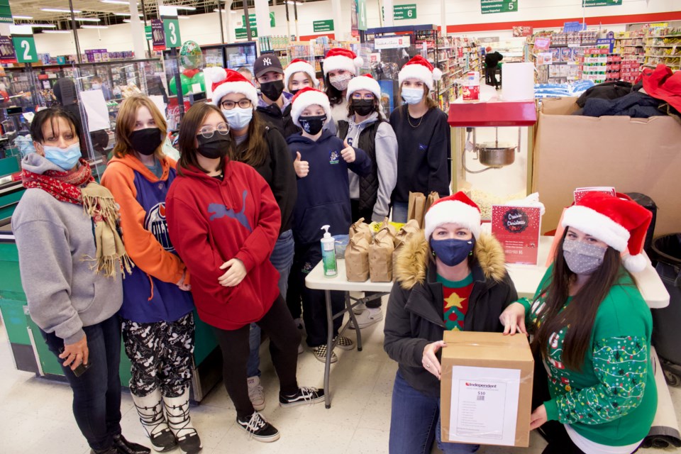 JAWS's staff and students from the career and life management class, and Interact Club at Thursday's ‘Crusin for Christmas’ food drive at Britton’s Your Independent Grocers.