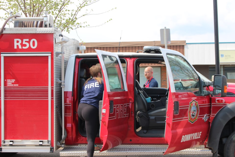 Volunteer firefighters leave the grill to rush off to a fire call during the Emergency Preparedness barbecue held at town hall on May 10.  