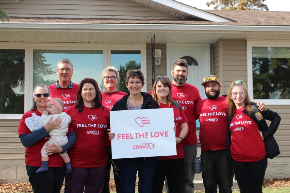 Lynd Robb (center) is joined by her friends, family and Precision Heating & Cooling employees, current and retired. Pictured right to left: Jensen Wenzel, Treven Flack, Brent Dutertre, Andrea Yaremie, Tracy Ohland Cintado, Kelsey Jeannotte, Glen Dutertre, and Janet Willcock.