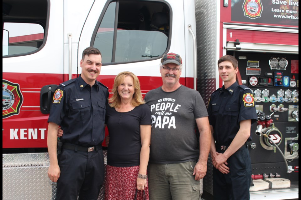 The Fort Kent fire hall open house was a perfect time to pose for a quick family photo. Pictured is firefighters Anthony McDaniel (left) and Tyrel Redmann (right) along with Jennie and David McDaniel.