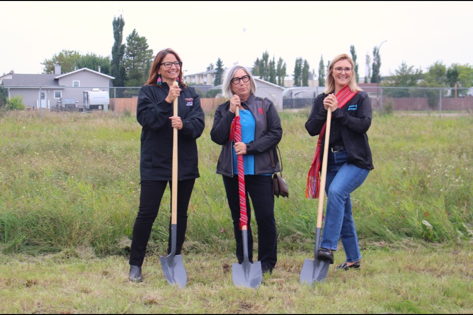 (Left to right) MNA vice president of Region II Andrea Sandmaier, MNA President Audrey Poitras and Town of Bonnyville Mayor Elisa Brosseau break ground on the Family Reunification Housing project slated to be built soon in the Town of Bonnyville. 