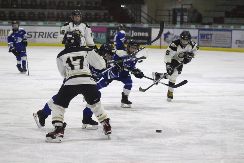 Pontiacs' player Chase Hunter, #17, creates a block against the fast approaching Cold Lake Ice player.
