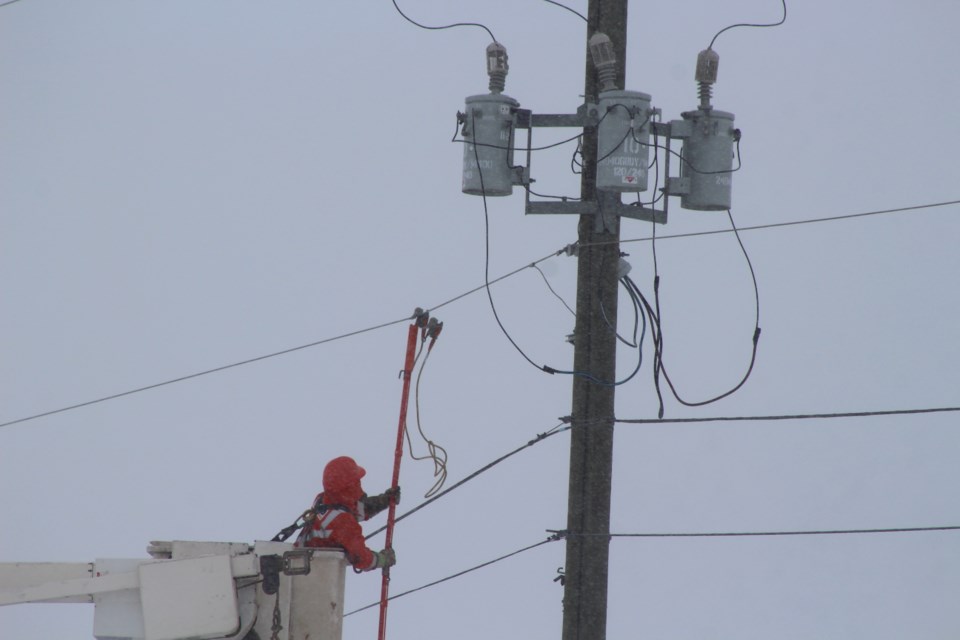 ATCO crews battle against blistering cold weather and high winds to correct downed power lines along 56 St. 