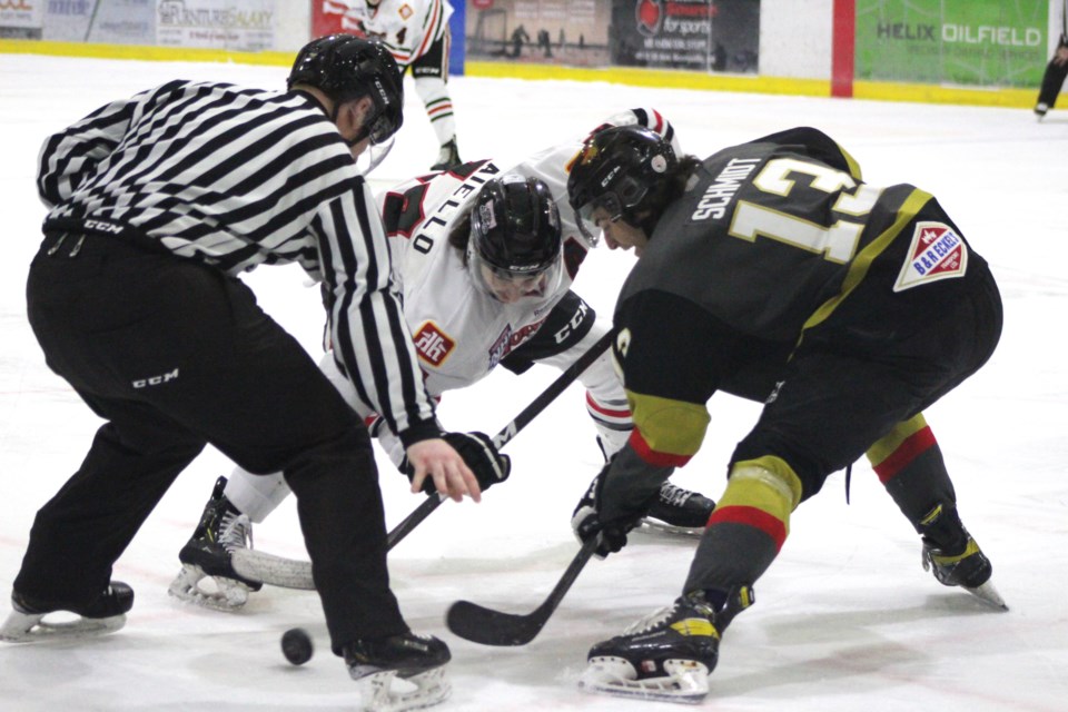 Pontiacs' player Chayce Schmidt faces off against his Whitecourt Wolverine opponent. 