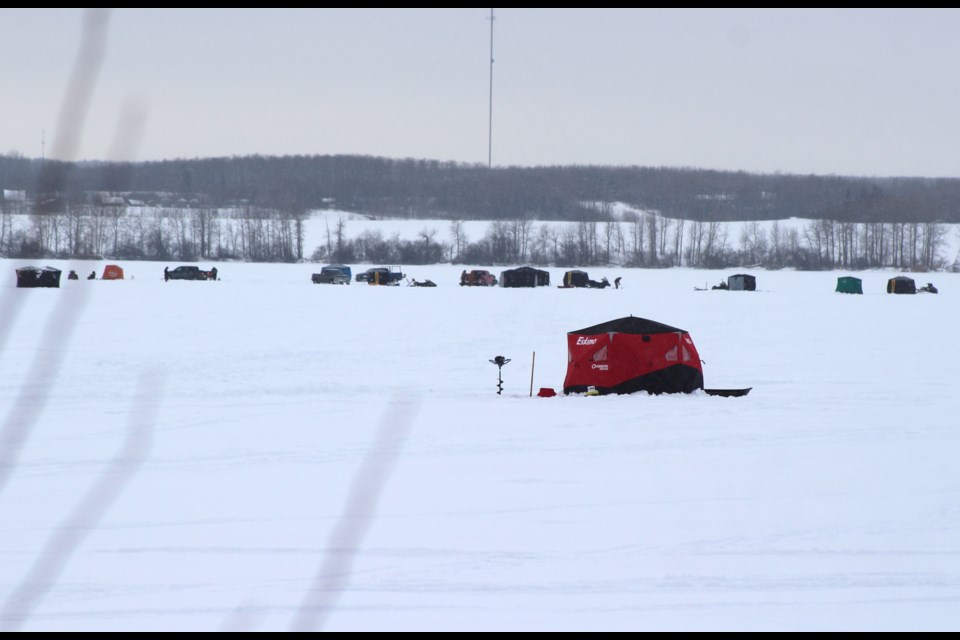 Dozens of tent covering fishing holes dotted Angling Lake on Saturday.