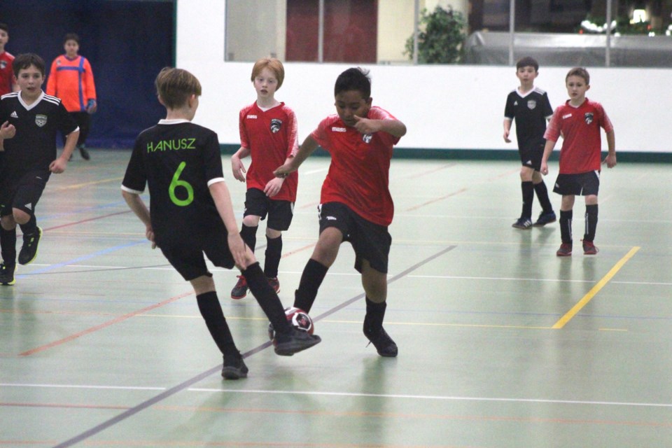 The players from the Cold Lake and Bonnyville U11 boys team battle for possession of the ball.