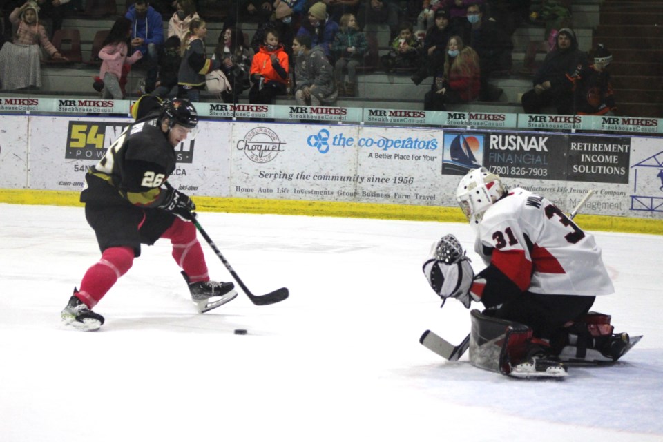 Pontiacs player Cole Hipkin takes a shot on the Kodiaks goaltender following a break away. 