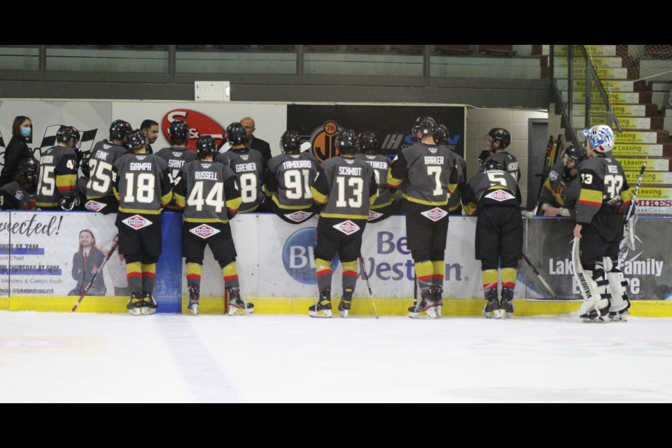 Pontiacs huddle around Coach Rick Swan during a time-out.