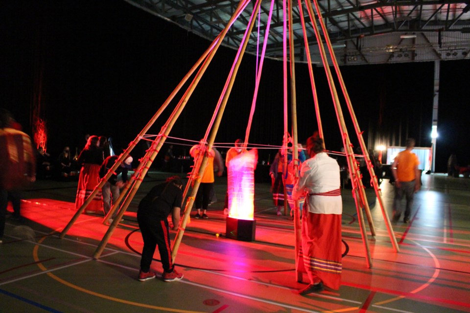 Closing the ceremony, guests in attendance were given the opportunity to tie red and orange ribbons to a teepee display set in the middle of the venue.