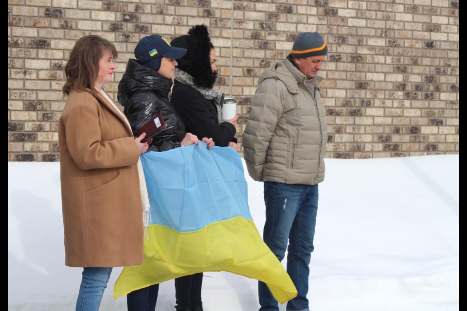 Members of the public attend the Town of Bonnyville's symbolic Ukrainian flag raising on Friday, as a show of solidarity for the Eastern European country who is currently fighting Russian military attacks against on several of the Country's cities. 