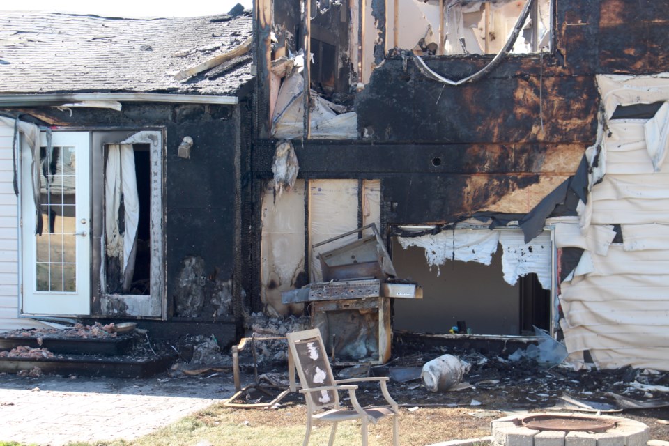 An initial investigation has been completed and it appears that the fire was started by a barbecue that was too close to the home. The barbecue is suspected of igniting the vinyl siding and spreading up the back wall and into the soffit venting.