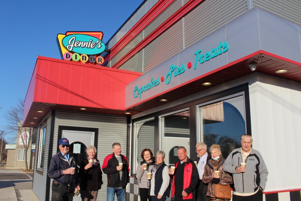 Local seniors stand defiantly outside of Jennie's Diner and Bakery drinking coffee and opposing AHS's decision to close the local eatery. 