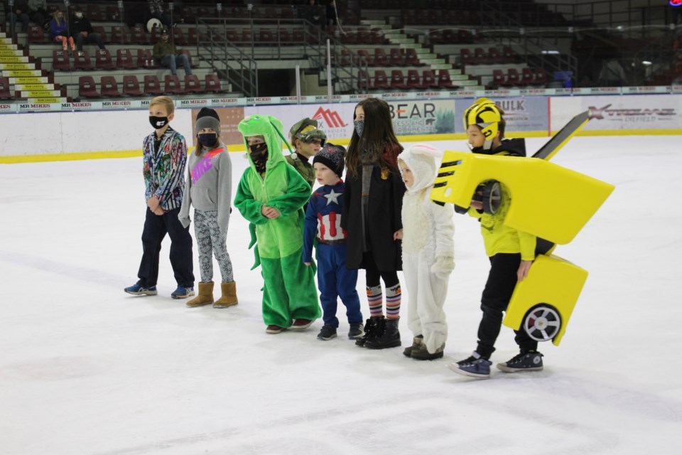 Pontiacs fans line the ice while they show off their costumes to the crowd.