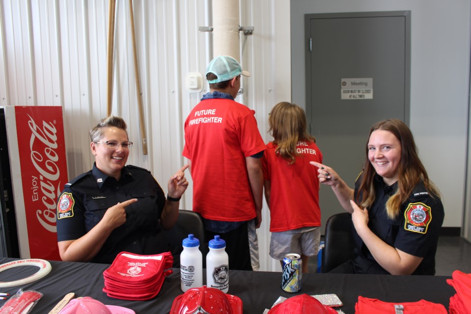 Gabe Weber and Miranda Firomski pose with Bonnyville Regional Fire Authority youth T-shirts with the slogan 'Future Firefighter.' The pair was joined by local firefighters Tiffany Bryks (left) and Lakota Bowers (right).