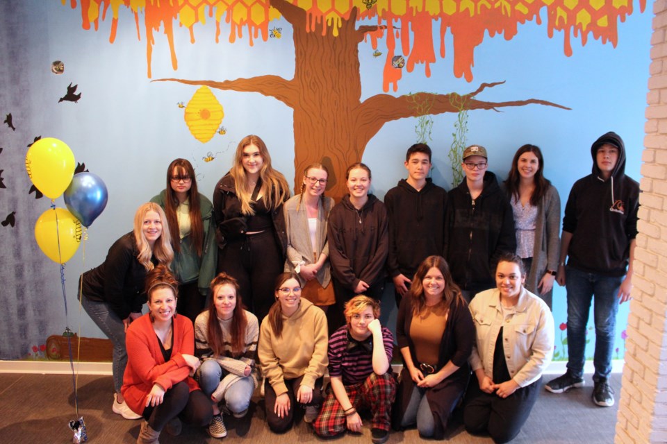 Youth volunteers and The Hive's youth coordinators took time on April 27 to relax and enjoy their two years of hard work, as well as the completion of a mural featured inside their new location.