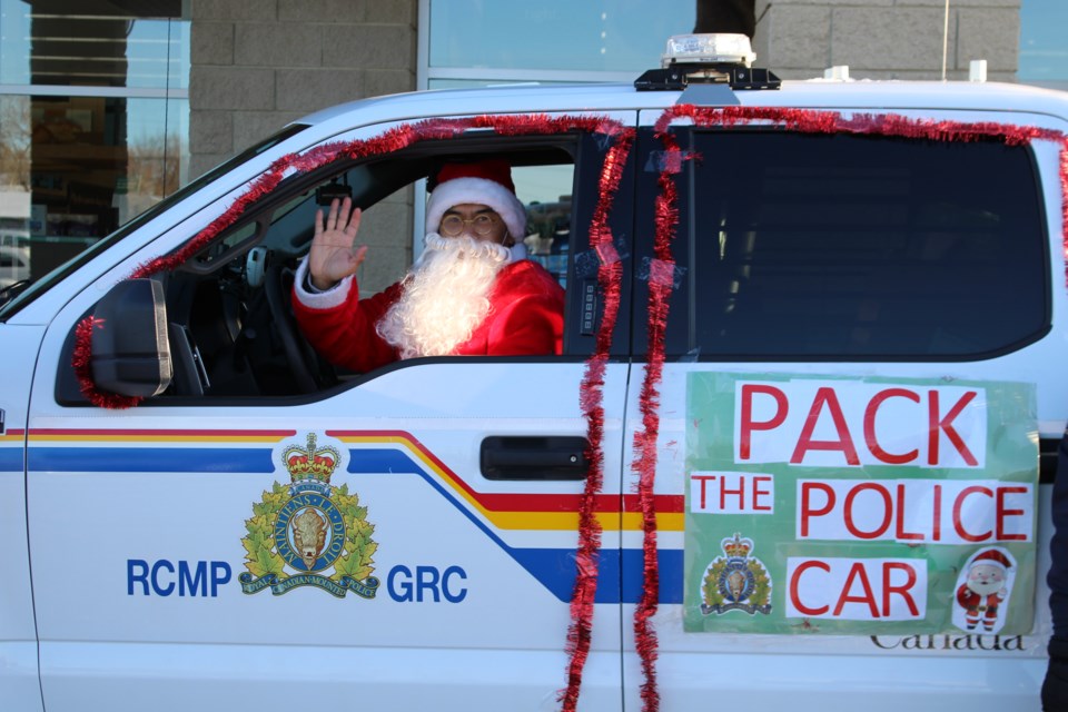 Making a special appearance, Santa Claus helps collect food donations for local food banks.