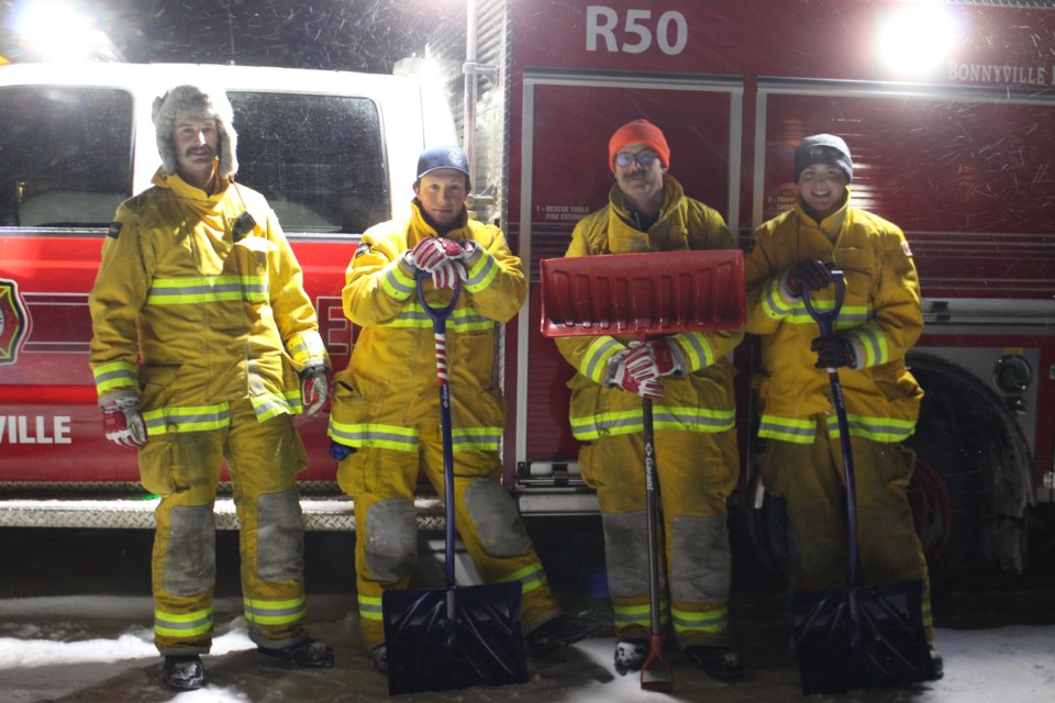 Bonnyville's Station 5 volunteer firefighter, Coltin Batke, Austin Jackson, Craig Wenzel and Taras Straughan (from left to right), lent a hand shoveling the walkways for Bonnyville residents participating FCSS Snow Angel program on the evening of Dec. 23. 