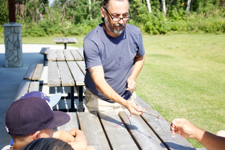 Métis outdoor enthusiast and host John Ritchie led a group of over a dozen participants in a hands on trapping tales experience on Aug. 13, 2022. The event hosted at Sir Winston Churchill Park community hall is a part of a month-long Indigenous learning experience.