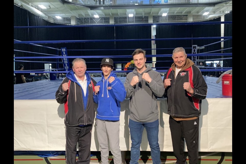 Bonnyville boxers Cooper Goliquer (center left) and Jeremy Fagnan (center right) had a successful showing at the Clash of the Titans III event held at the Cold Lake Energy Centre on March 4. The local fighters were joined by their K.A. Boxing coaches Ray Kahanyshyn (left) and Ray Dumais (right). 