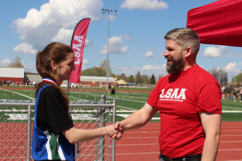 Kiera Thomas from École McTavish was awarded a gold medal for completing the Girls Intermediate 1,500 meter run in  5 minutes and 54 seconds. Thomas also received silver in the 800 meter run. Presenting the medal was École Voyageur teacher Sacha Roussel. 