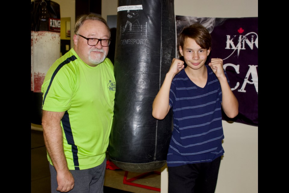 Lac La Biche Boxing Club head coach Ken Scullion (left) and boxer Michael Manuel Gardner during a training session on Nov. 10, 2022.