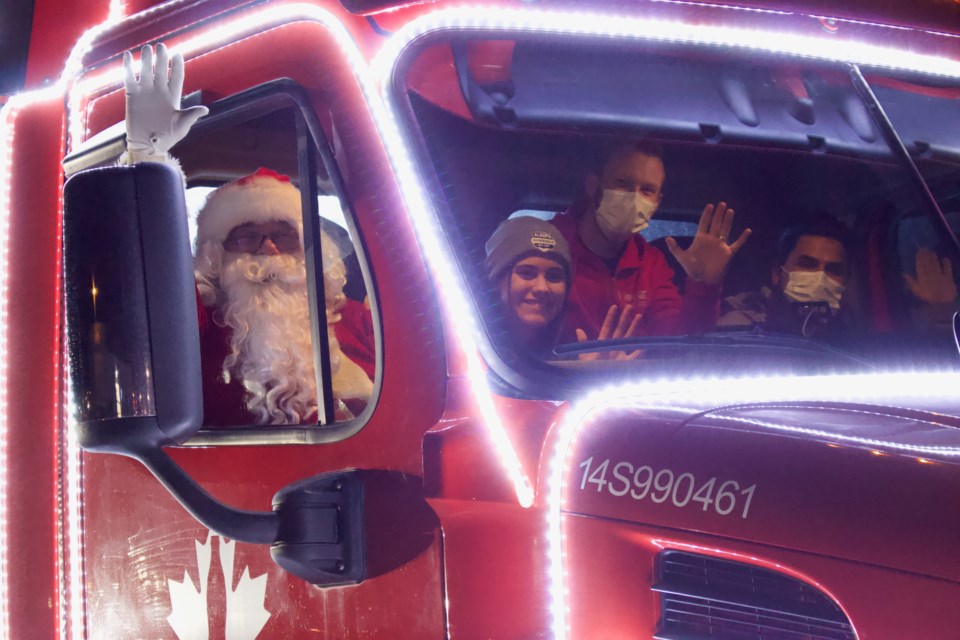 This year, at the 'Light Up the Night' parade, Santa and the 2021 Junior Citizen of the Year recipient Ainsley Kruk pulled up in a decorated Coca-Cola truck donated by Britton's Your Independent Grocer and Coca-Cola.