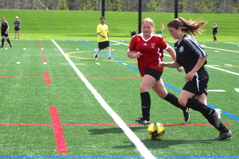 Vermilion U15 Girls team (red jerseys) takes on the Bonnyville-Lac La Biche United team (black jerseys) at the Varughese Memorial Field, Cold Lake, on June 19.