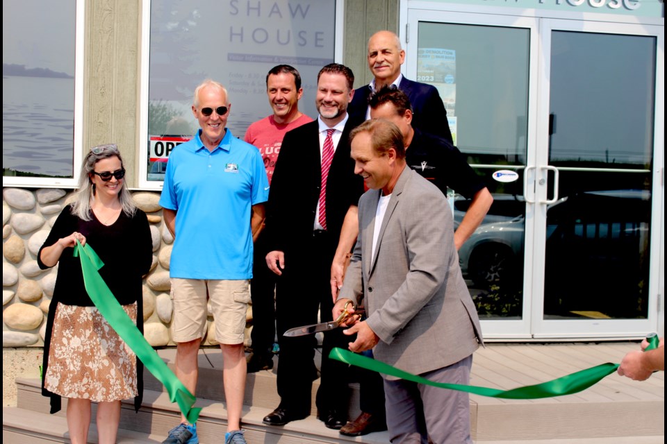 Reeve Barry Kalinski cuts the ribbon marking the ceremonial opening of the Shaw House Visitor Information and Interpretive Centre. The reeve was joined by MD of Bonnyville councillors Dana Swigart, Josh Crick, Don Slipchuk, Ben Fadeyiw, as well as local MLA Scott Cyr, and Esther Quiambao, the MD's general manager of Planning & Community Services.