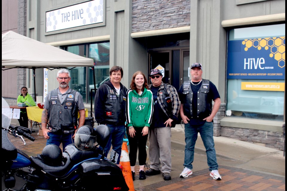 Lakeland members from the non-profit Protection for the Unprotected ran a sidewalk barbecue for The Hive's birthday bash celebration. Pictured from left to right are  Protection for the Unprotected members Bryce LeBlanc, Jim Dillon, Kathryn Petitpas, Shawn Zummack and Eric Ouellet.