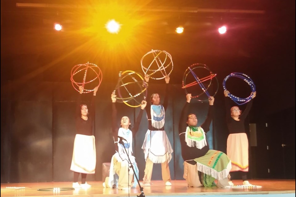 Local youth, Charles Cardinal, Garret Cardinal, Sekoya Weaselhead-Kehewin, Kimowan Weaselhead-Kehewin and Elizabeth Tucker, perform in the 'Dancing under the 13 moons' play on July 28 at École Notre Dame High School.