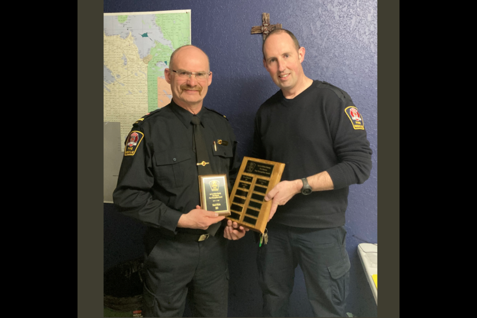 Owl River Fire hall senior captain Mark Wiebe (left) receives the 2021 Lac La Biche County Fire Rescue Peer Recognition Award, presented by Chris Newhook, Fire Services Coordinator on March 8.
